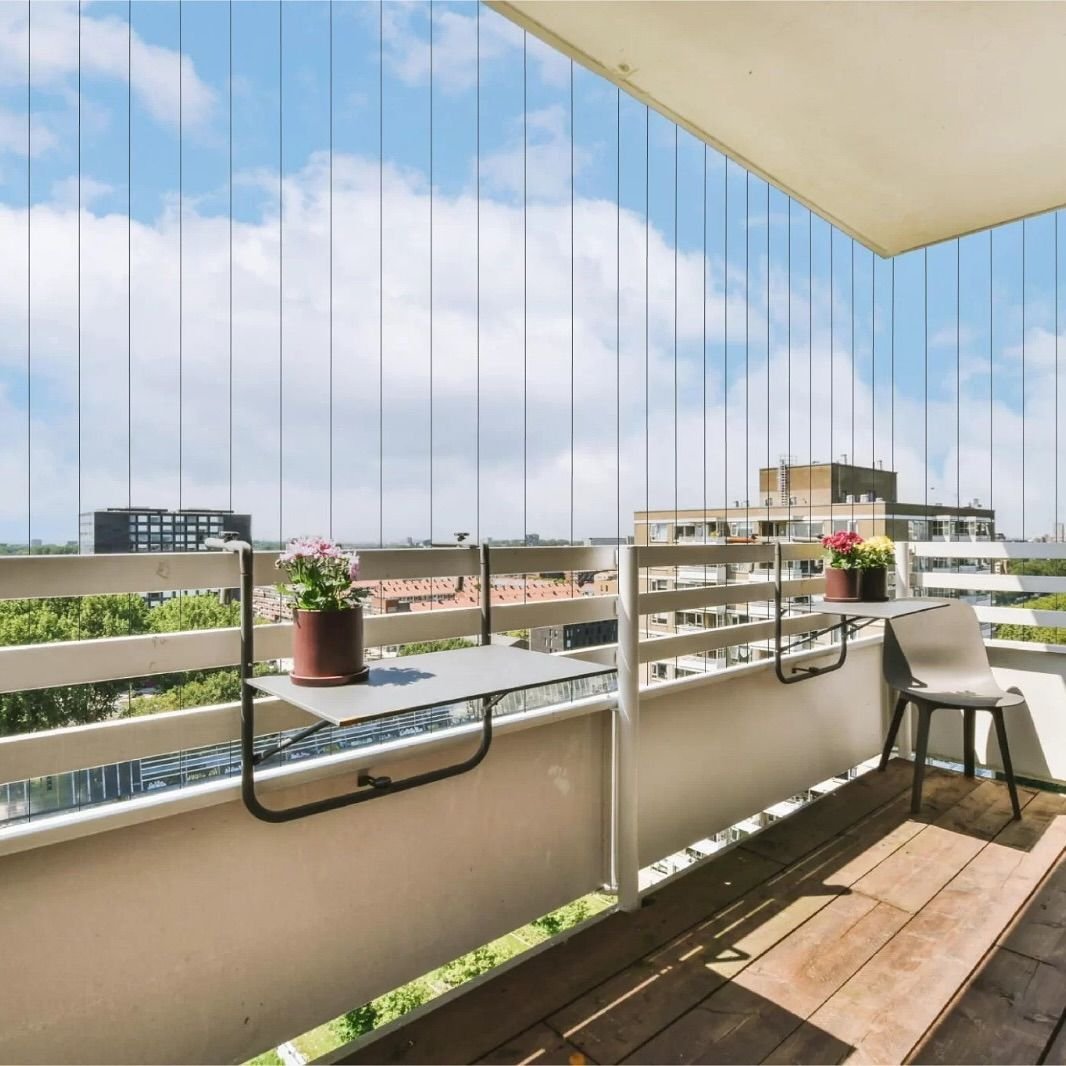 Invisible grills on modern apartment windows in Bangalore by Tharak Enterprises